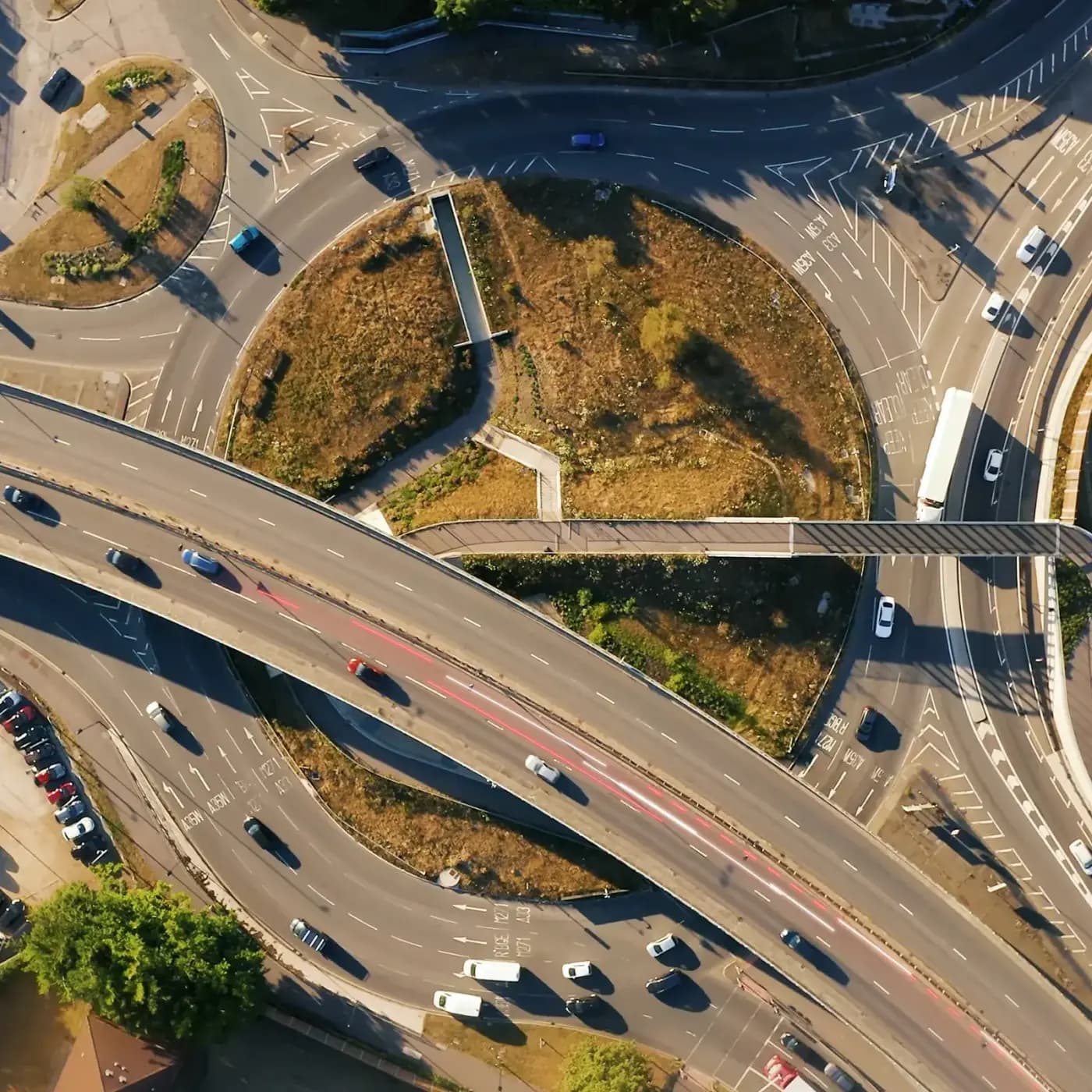 Aerial shot of intersecting motorways with traffic including HGVs and data trails