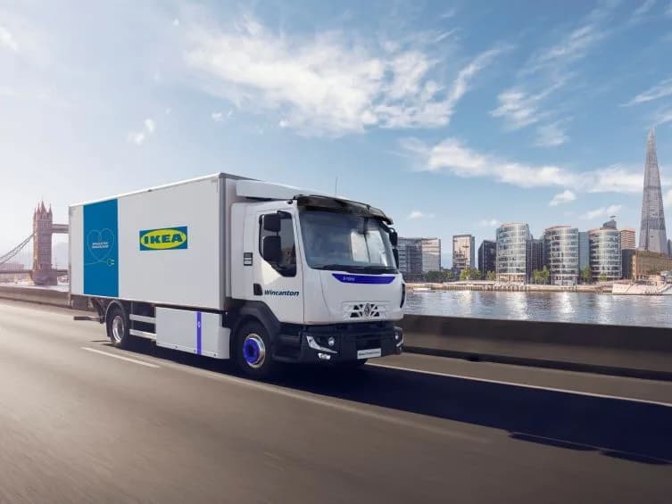 IKEA-branded Wincanton 100% electric home delivery truck on a London bridge with Tower Bridge and the Shard in view
