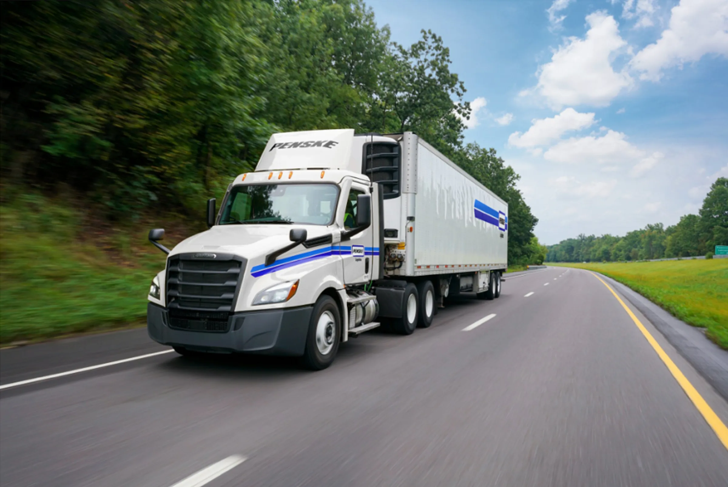 White Penske tractor-trailer on a US highway from the Bridgestone and Penske Decarbonization Lab case study with Dynamon