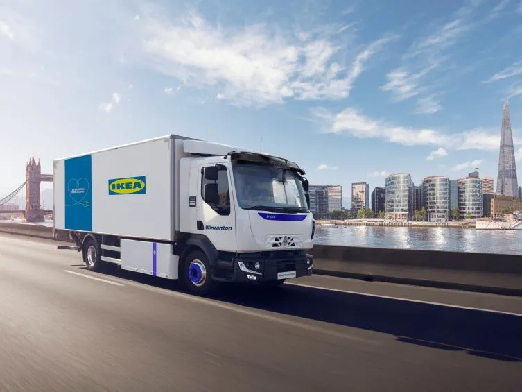 IKEA-branded Wincanton 100% electric home delivery truck on a London bridge with Tower Bridge and the Shard in view